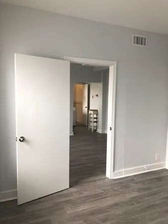 a view of a hallway with wooden floor