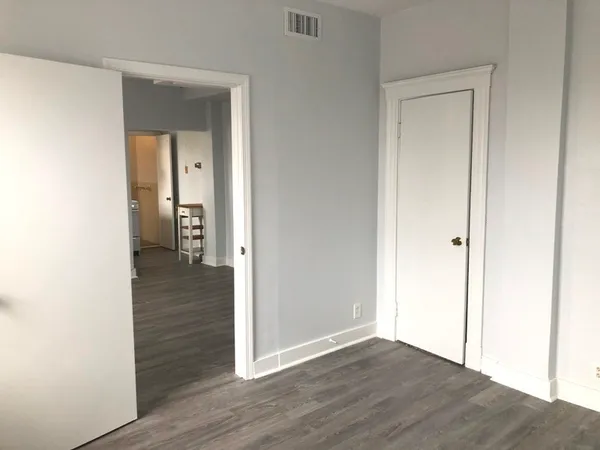 a view of a hallway with wooden floor