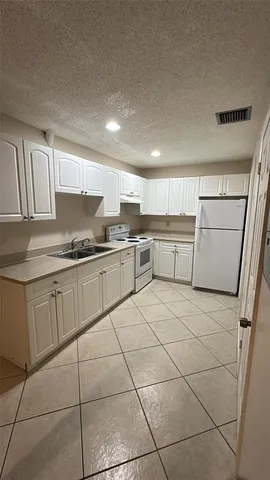 a kitchen with appliances cabinets and a sink