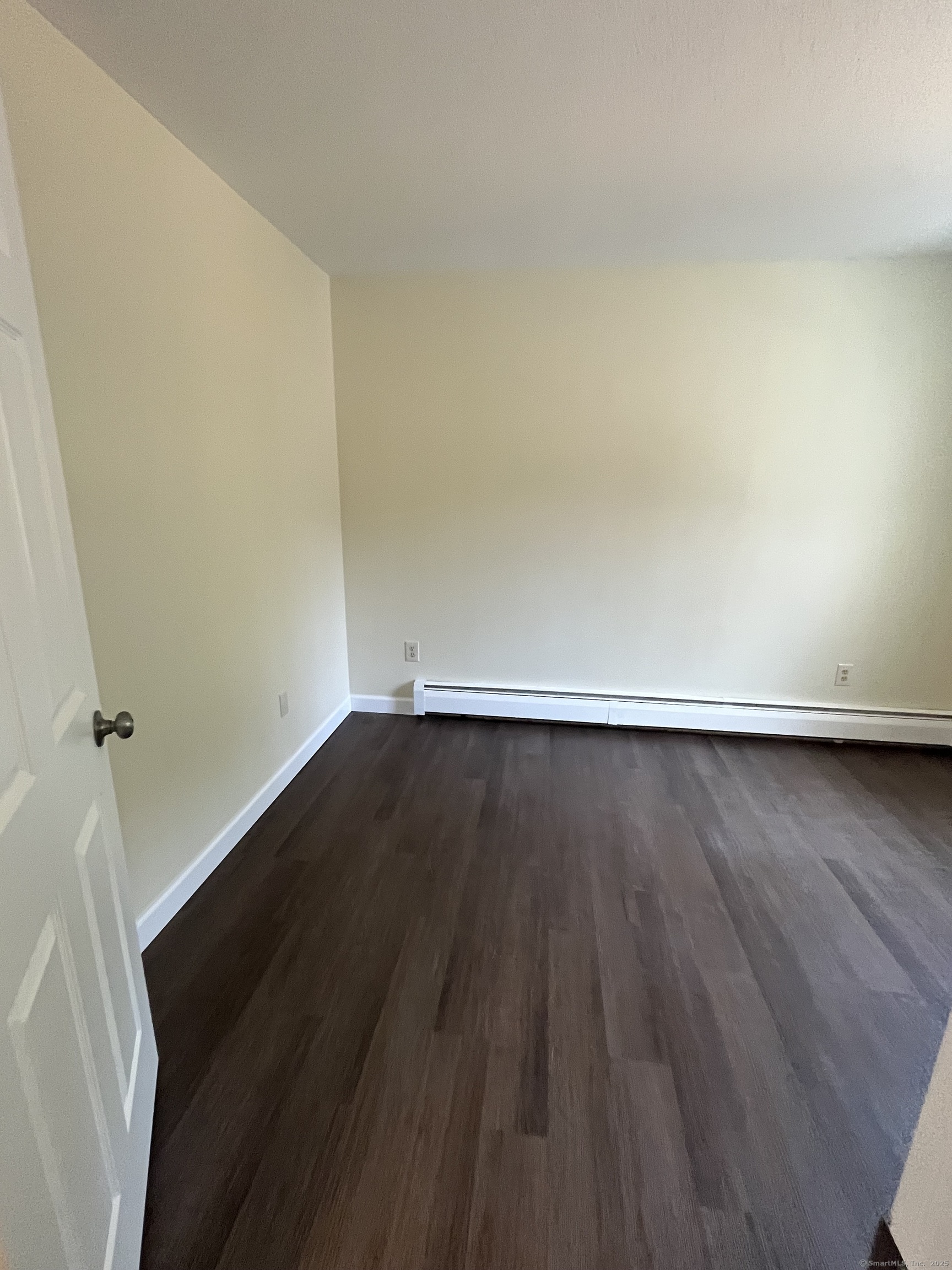 61 Arch Street, Unit 1 Burlington, CT 06013 - Photo 16 of 22 a view of room with wooden floor and white walls