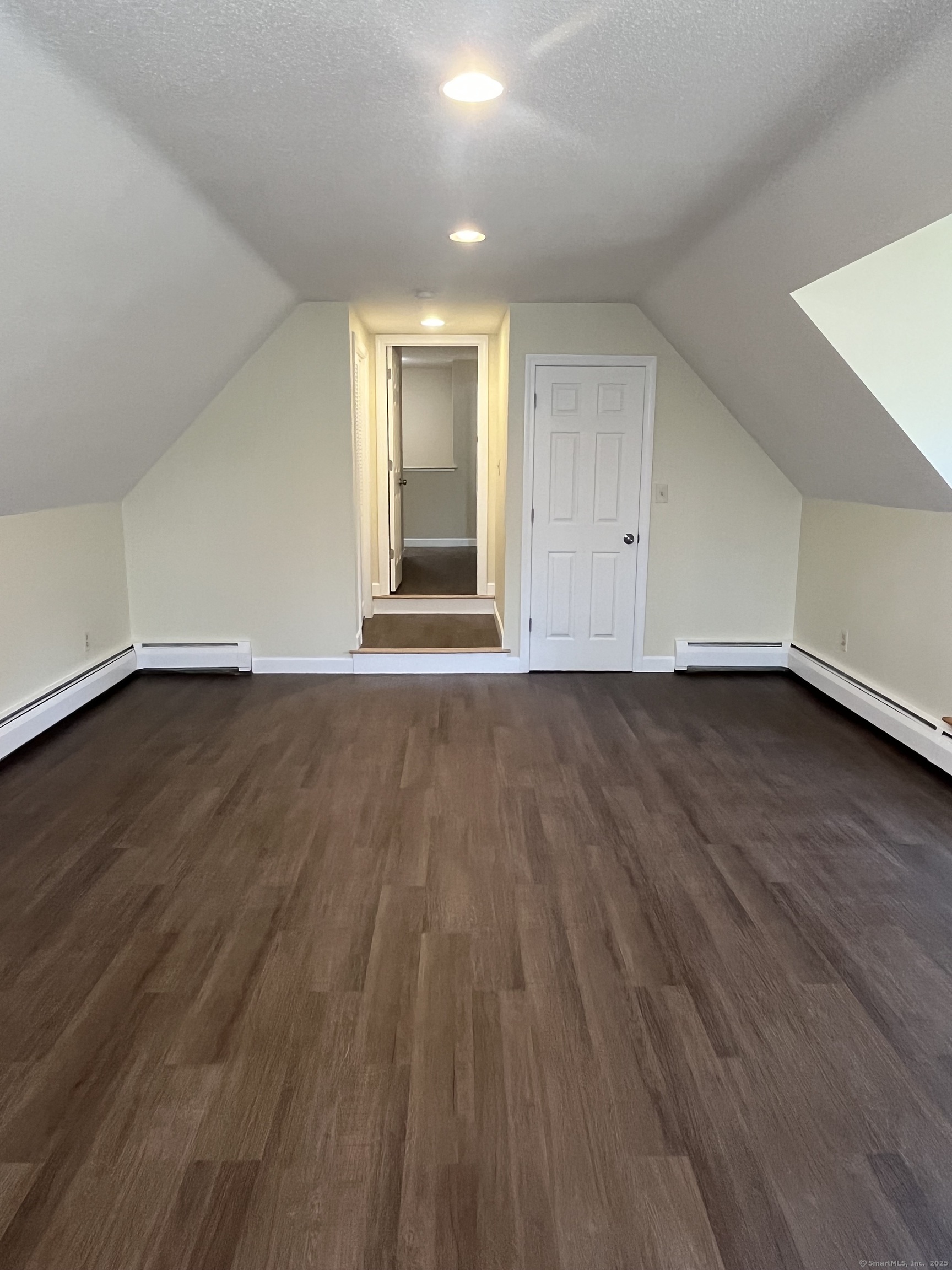 61 Arch Street, Unit 1 Burlington, CT 06013 - Photo 19 of 22 a view of an empty room and wooden floor