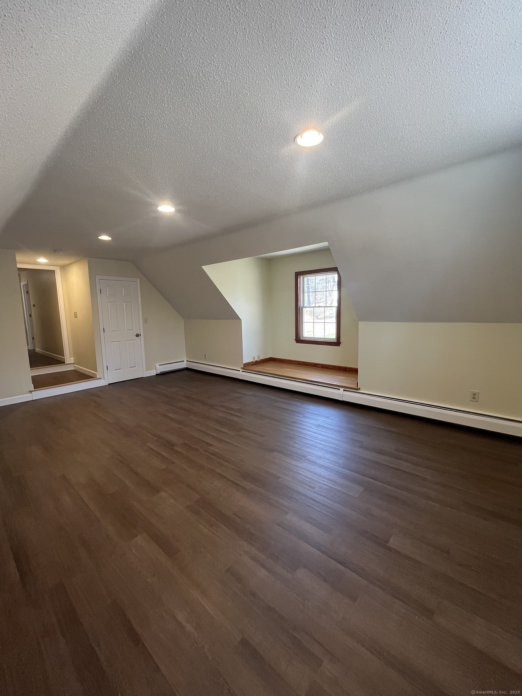 61 Arch Street, Unit 1 Burlington, CT 06013 - Photo 20 of 22 an empty room with wooden floor and windows