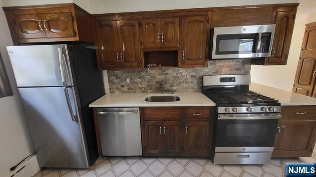 47 Hackensack Avenue Ridgefield Park, NJ 07660 - Photo 11 of 36 a kitchen with stainless steel appliances wooden cabinets and a stove top oven