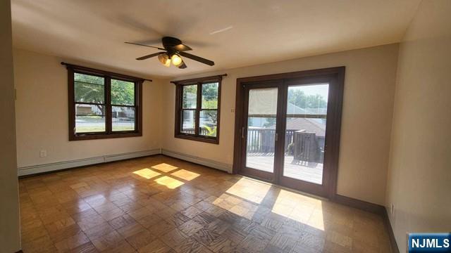 47 Hackensack Avenue Ridgefield Park, NJ 07660 - Photo 16 of 36 an empty room with windows and ceiling fan