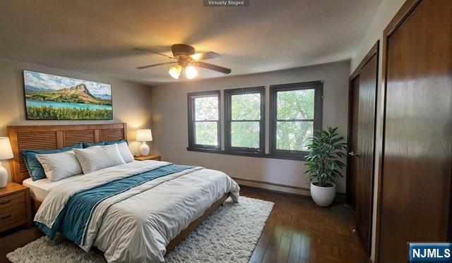 47 Hackensack Avenue Ridgefield Park, NJ 07660 - Photo 18 of 36 a bedroom with a large bed and a potted plant