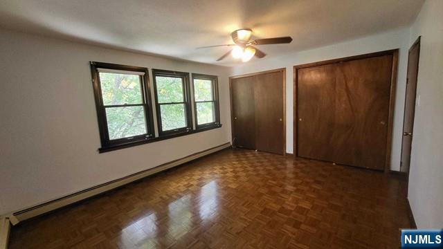 47 Hackensack Avenue Ridgefield Park, NJ 07660 - Photo 20 of 36 an empty room with chandelier fan and windows