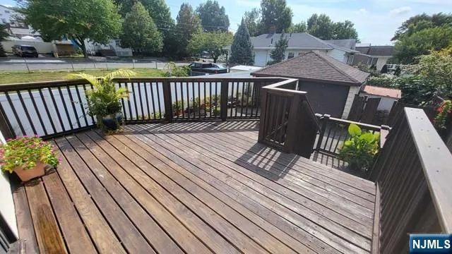 a view of balcony with wooden floor and outdoor seating