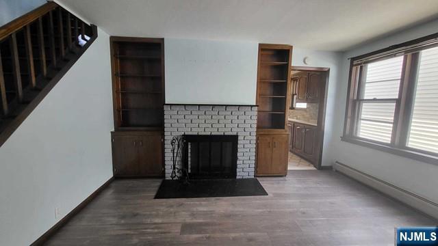 47 Hackensack Avenue Ridgefield Park, NJ 07660 - Photo 8 of 36 a living room with furniture and a fireplace