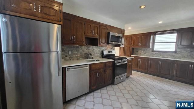 47 Hackensack Avenue Ridgefield Park, NJ 07660 - Photo 10 of 36 a kitchen with stainless steel appliances granite countertop a refrigerator stove a sink dishwasher and microwave