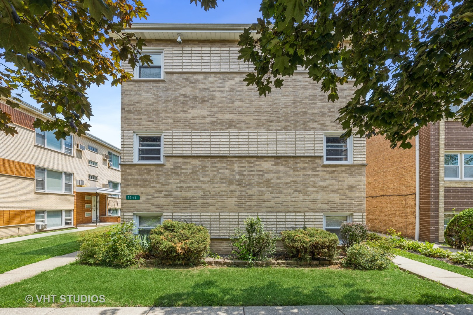 2245 Des Plaines Avenue, Unit C North Riverside, IL 60546 - Photo 2 of 15 a brick house with a yard plants and large tree