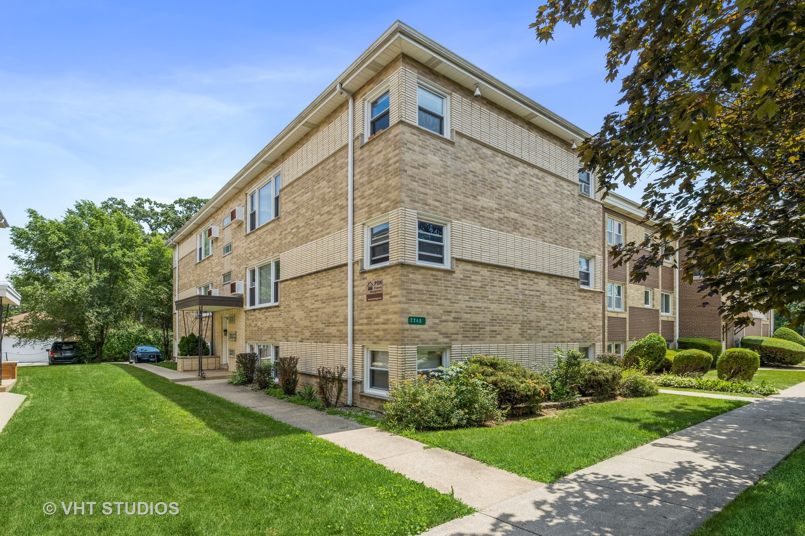 2245 Des Plaines Avenue, Unit C North Riverside, IL 60546 - Photo 3 of 15 a large brick building with a big yard and large trees