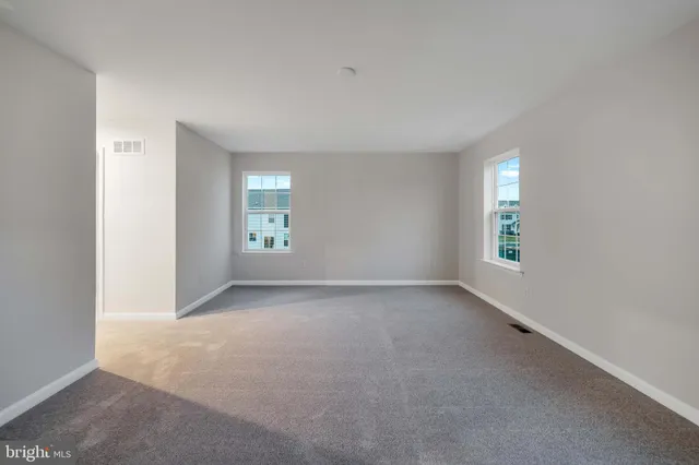 an empty room with windows and closet