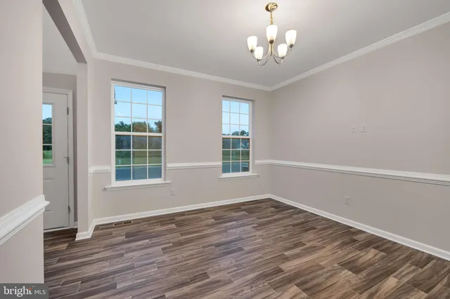 a view of wooden floor and windows in a room