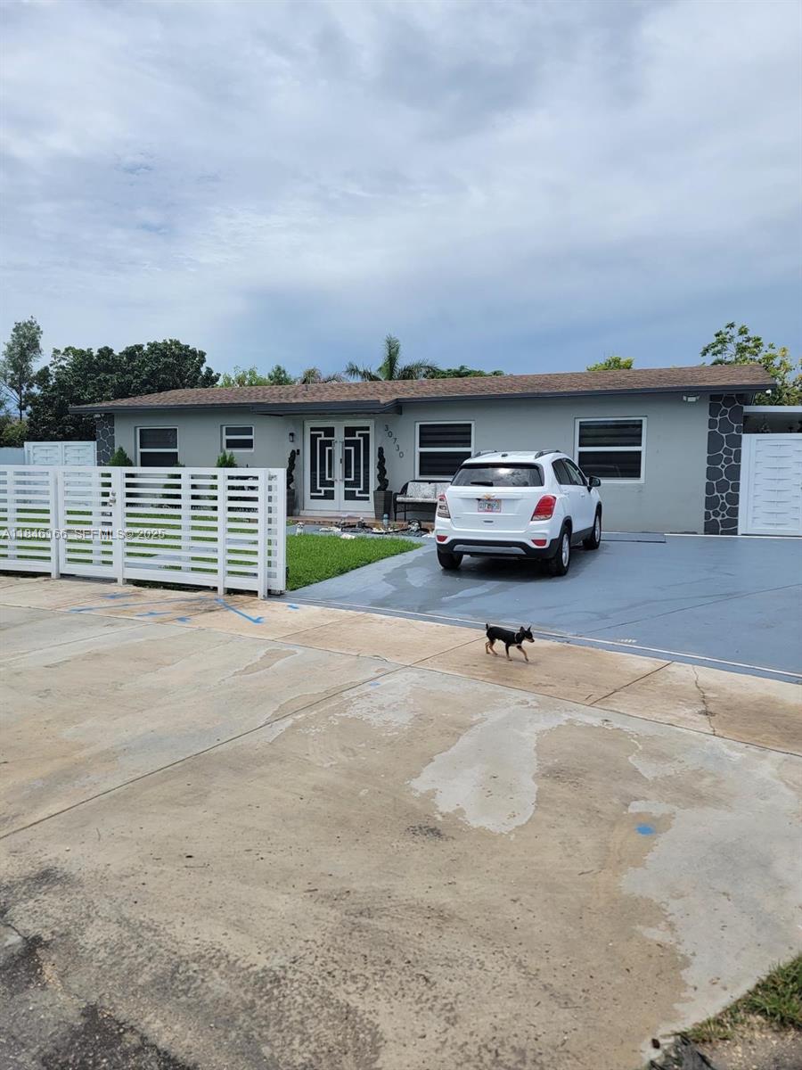 30730 Southwest 156th Avenue Homestead, FL 33033 - Photo 1 of 24 a car parked in front of a house