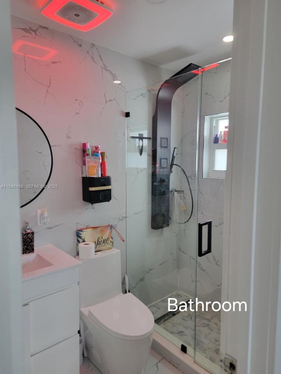 30730 Southwest 156th Avenue Homestead, FL 33033 - Photo 12 of 24 a bathroom with a sink a toilet and a mirror
