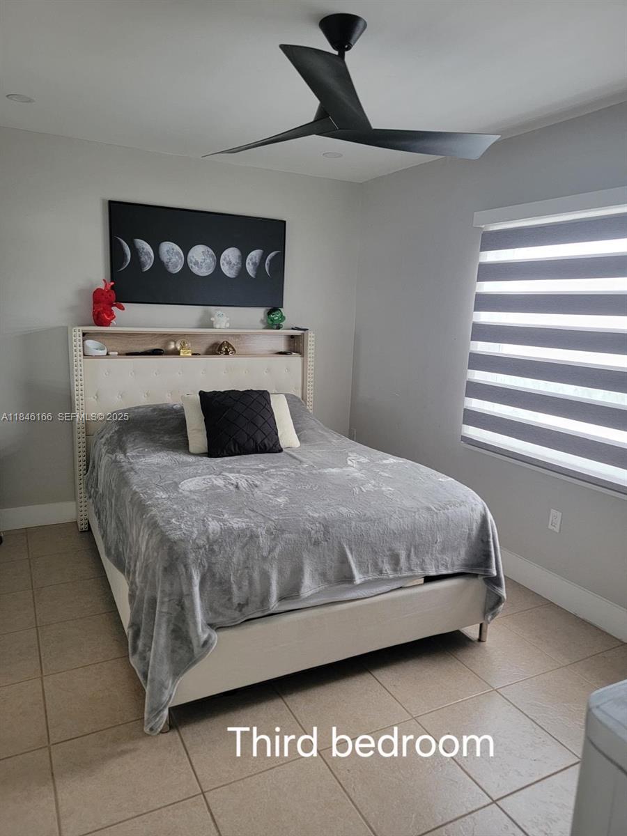 30730 Southwest 156th Avenue Homestead, FL 33033 - Photo 18 of 24 a bedroom with a bed and a window
