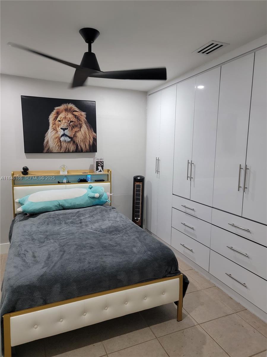 30730 Southwest 156th Avenue Homestead, FL 33033 - Photo 24 of 24 a bedroom with a bed and ceiling fan