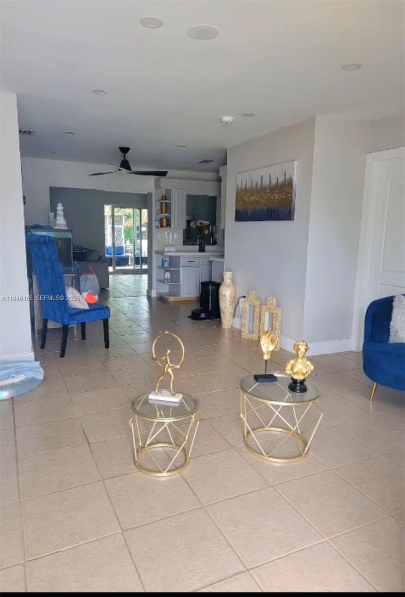 30730 Southwest 156th Avenue Homestead, FL 33033 - Photo 5 of 24 a living room with furniture and white walls