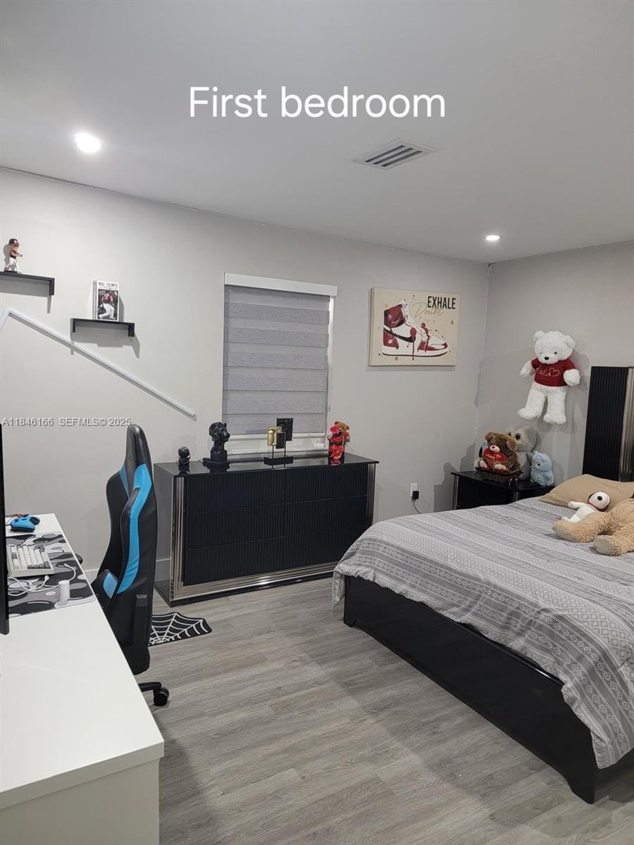 30730 Southwest 156th Avenue Homestead, FL 33033 - Photo 6 of 24 a bedroom with a bed and wooden floor