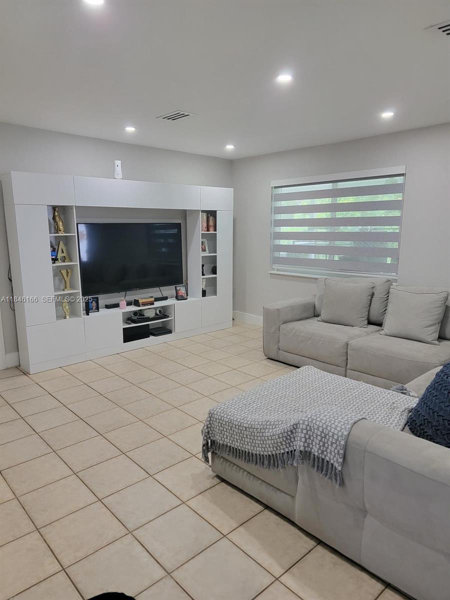 30730 Southwest 156th Avenue Homestead, FL 33033 - Photo 9 of 24 a living room with furniture and a flat screen tv