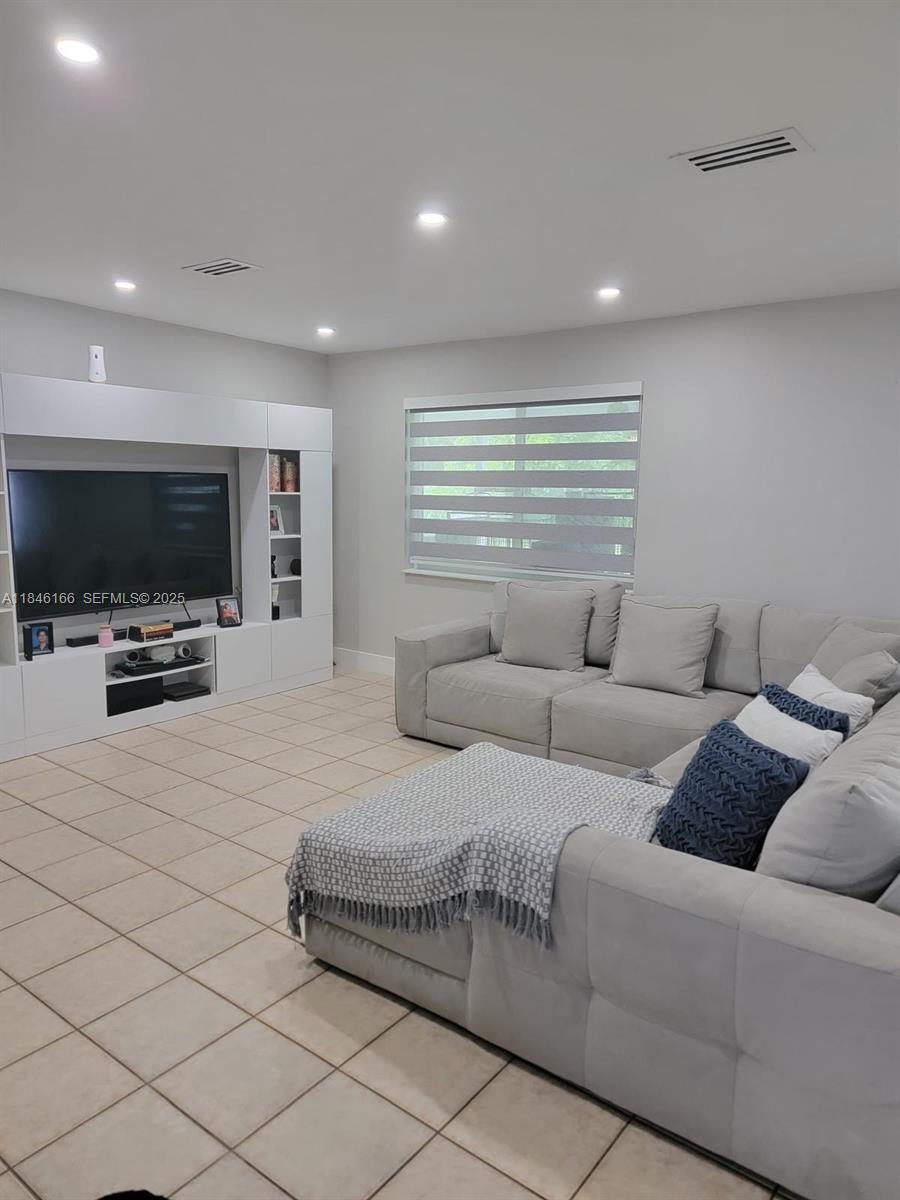 30730 Southwest 156th Avenue Homestead, FL 33033 - Photo 10 of 24 a living room with furniture and a flat screen tv