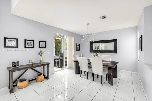a kitchen with white cabinets stainless steel appliances and a window