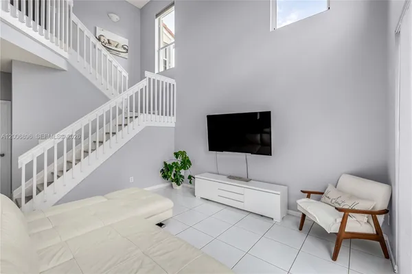 a living room with furniture and a flat screen tv