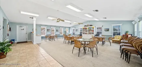 a living room with lots of furniture and a large window