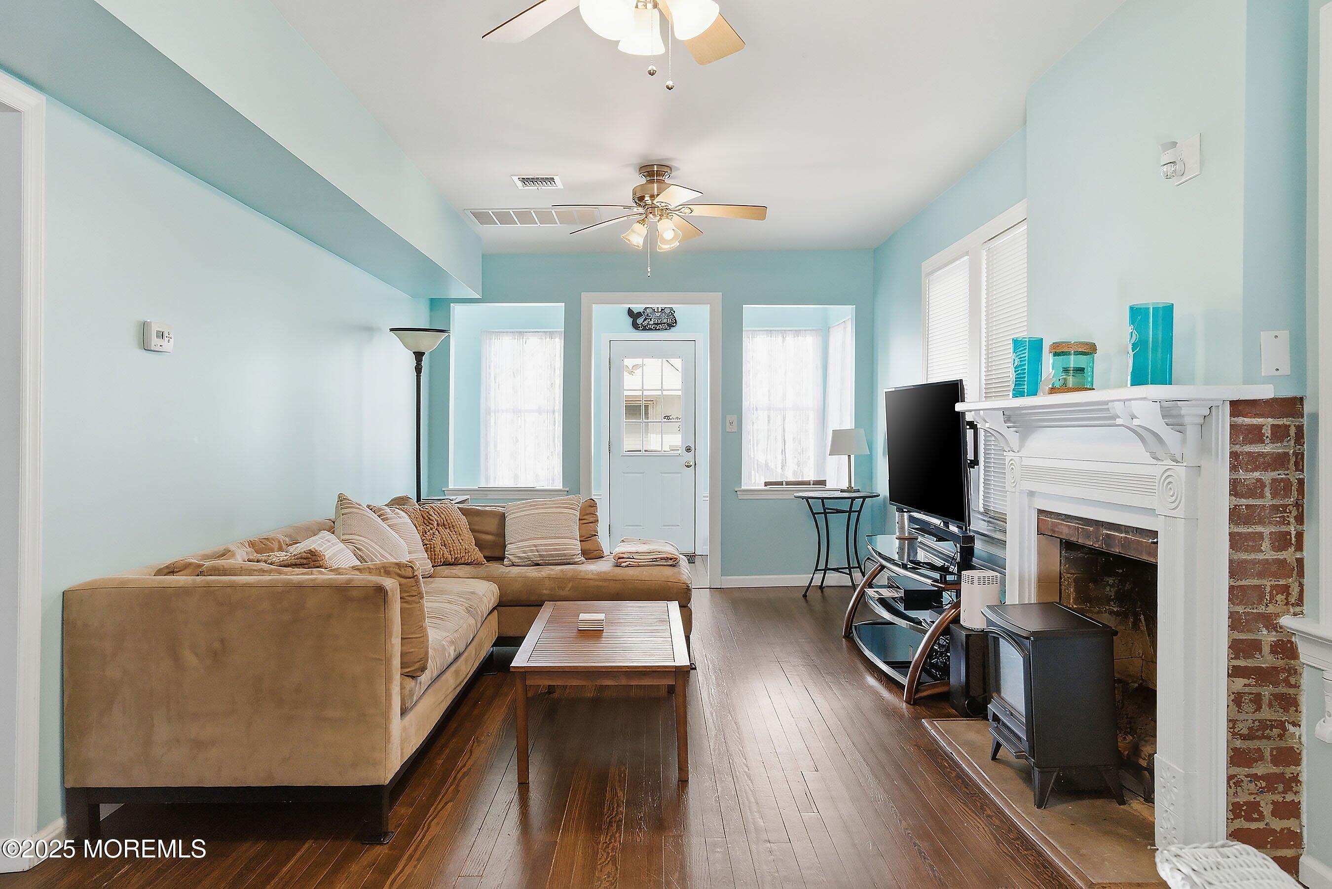34 Waterview Way Sea Bright, NJ 07760 - Photo 11 of 24 a living room with furniture a fireplace and a flat screen tv
