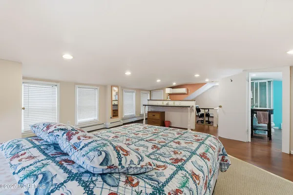 a spacious bedroom with a large bed and a large window