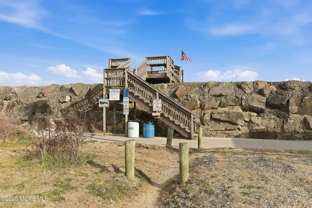 a balcony with wooden floor and city view