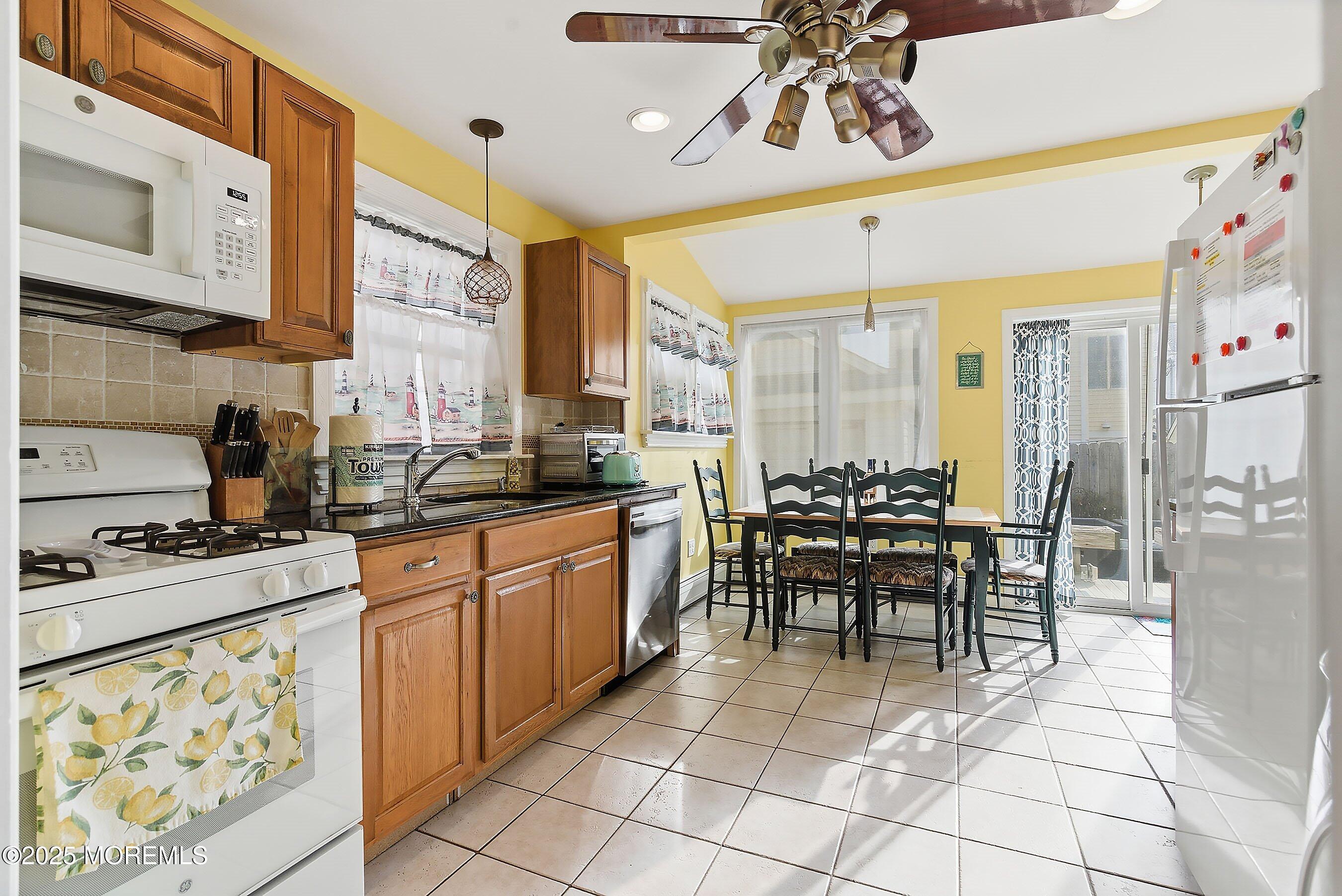 34 Waterview Way Sea Bright, NJ 07760 - Photo 7 of 24 a kitchen with stainless steel appliances granite countertop a stove a sink and a microwave