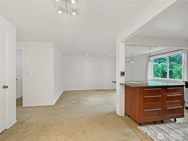 an empty room with a window and cabinet