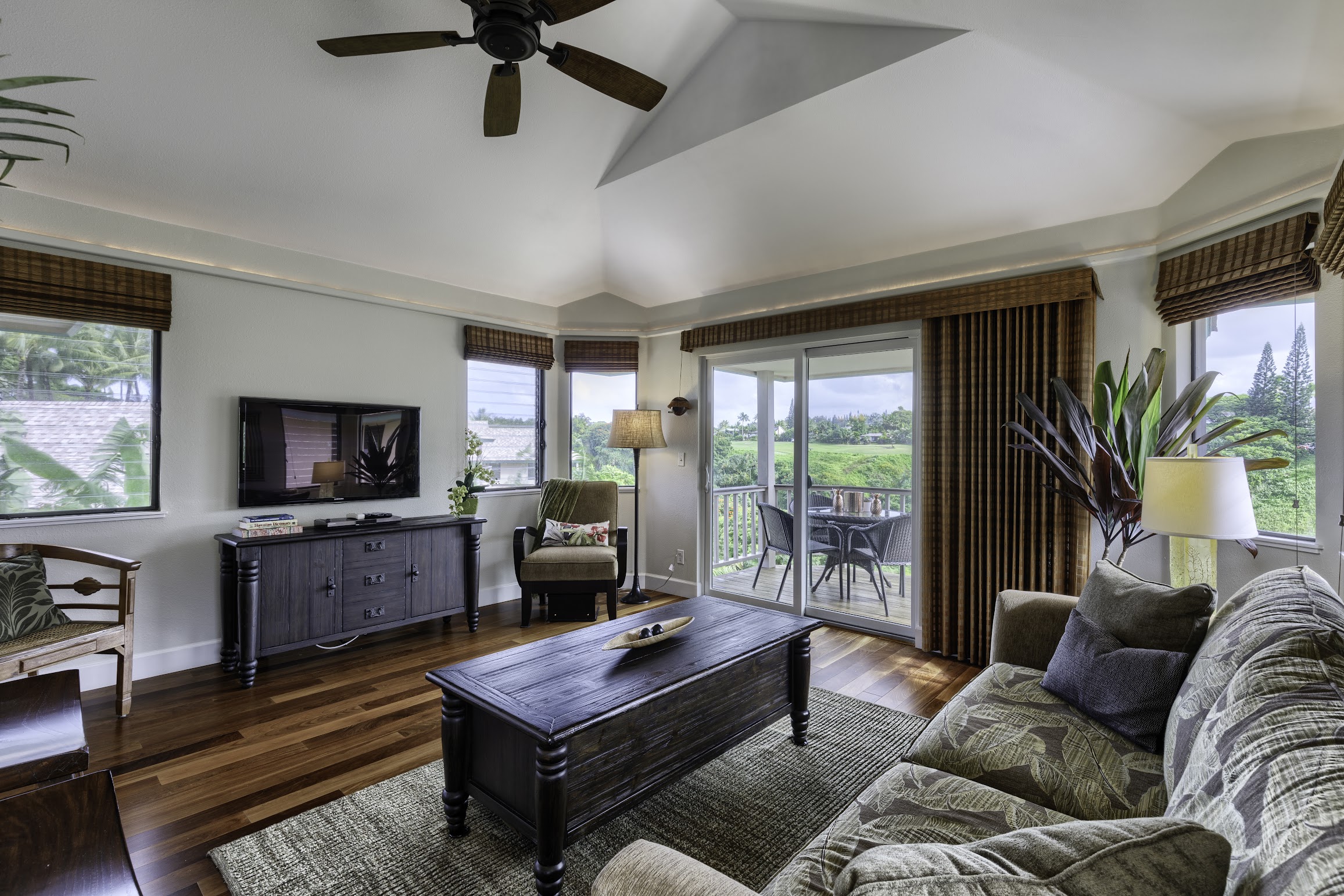 5451 Ka Haku Road, Unit 8 Princeville, HI 96722 - Photo 4 of 14 a living room with furniture and a flat screen tv