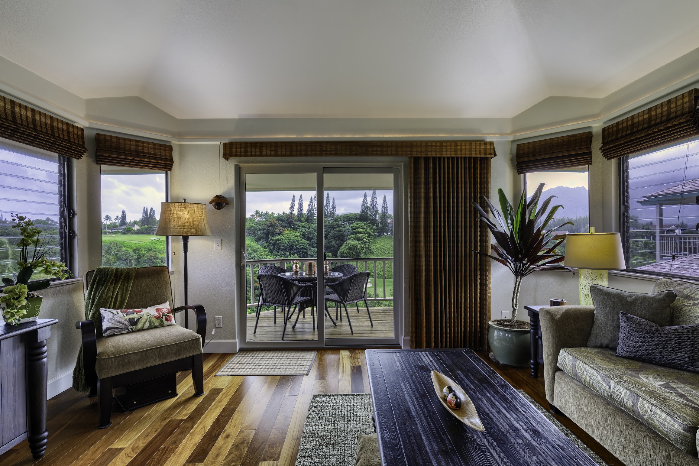 5451 Ka Haku Road, Unit 8 Princeville, HI 96722 - Photo 5 of 14 a living room with furniture and a floor to ceiling window