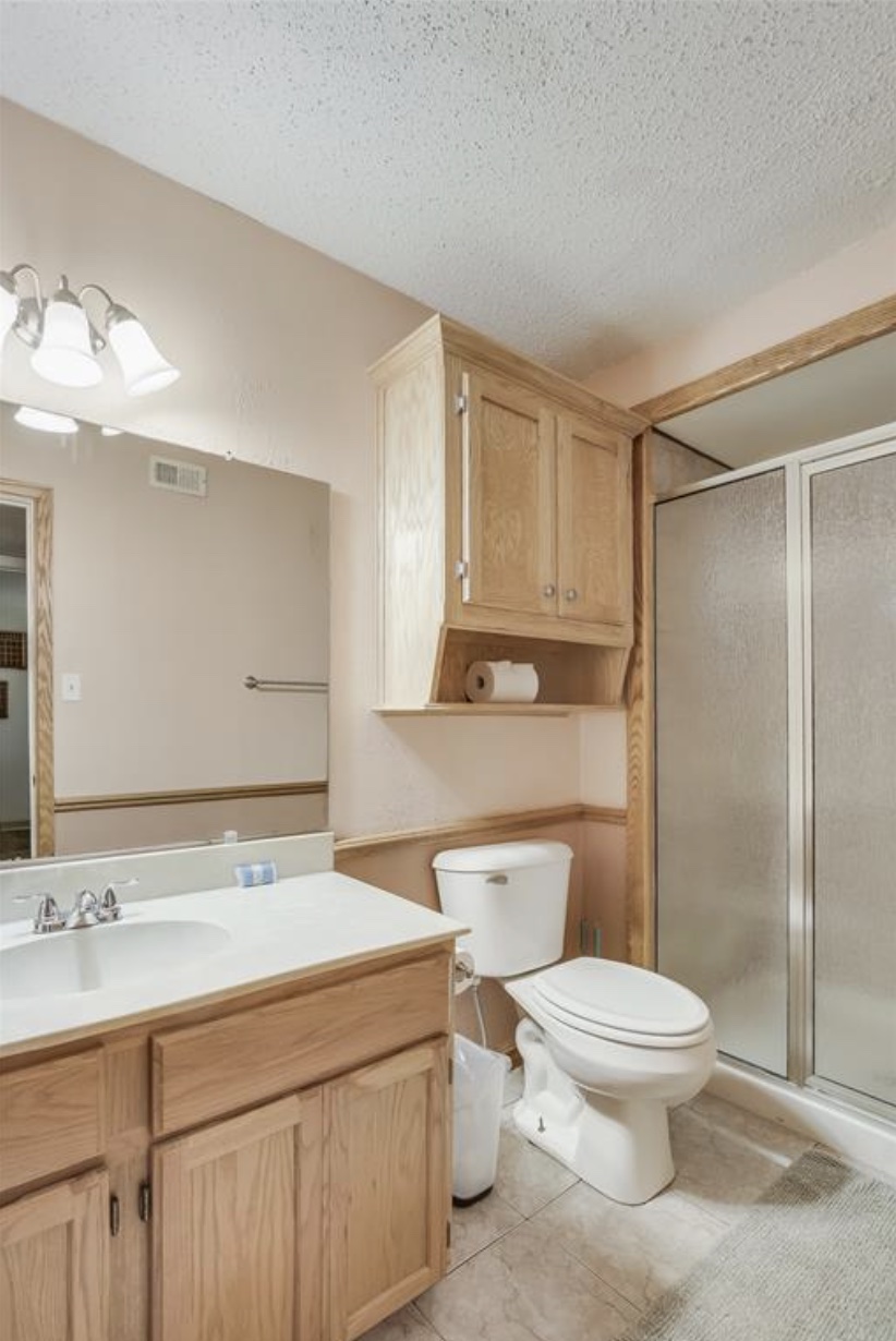 Undisclosed Address Point Venture, TX 78645 - Photo 16 of 31 a bathroom with a toilet sink and mirror