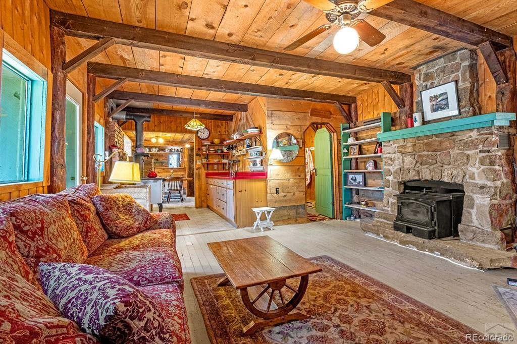 8929 Apache Drive Beulah, CO 81023 - Photo 11 of 43 a living room with furniture a flat screen tv and a fireplace