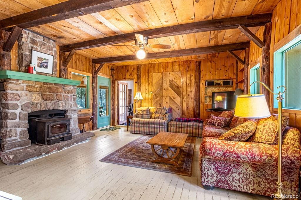 8929 Apache Drive Beulah, CO 81023 - Photo 19 of 43 a living room with furniture a fireplace and a flat screen tv