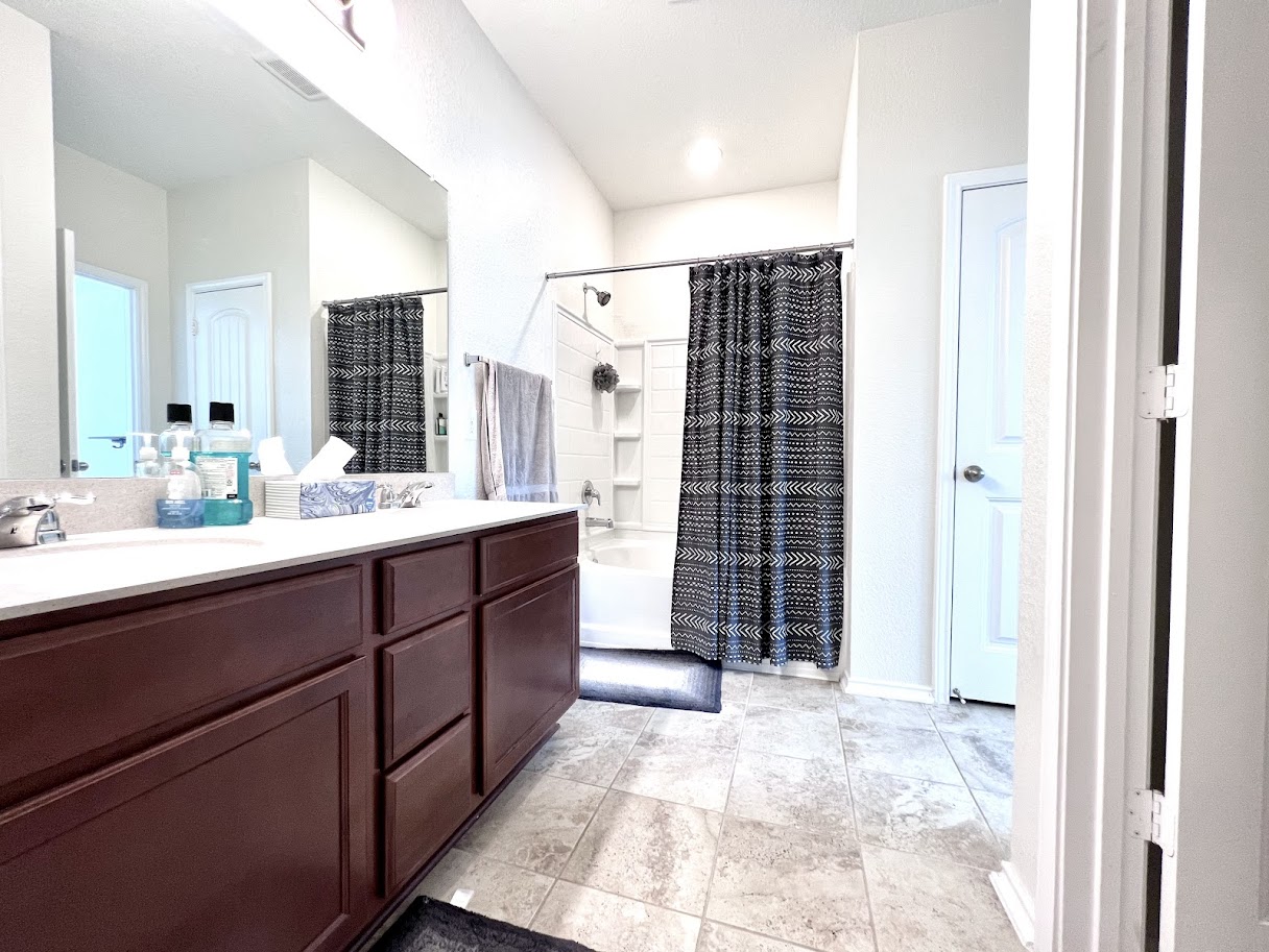 7900 Crystalbrook West Austin, TX 78724 - Photo 26 of 27 a bathroom with a sink double vanity and a shower