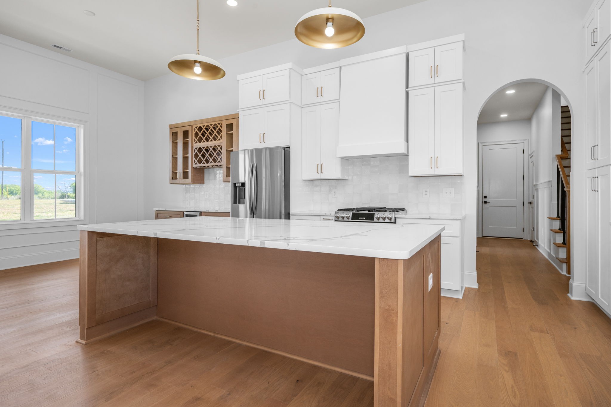 7838 Woodfin Road Christiana, TN 37037 - Photo 11 of 57 a kitchen with stainless steel appliances granite countertop a sink a stove and a wooden floors