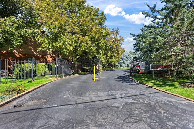 1120 Canyon Road, Unit 38 Ogden, UT 84404 - Photo 4 of 24 View of asphalt road featuring curbs and a gated entry