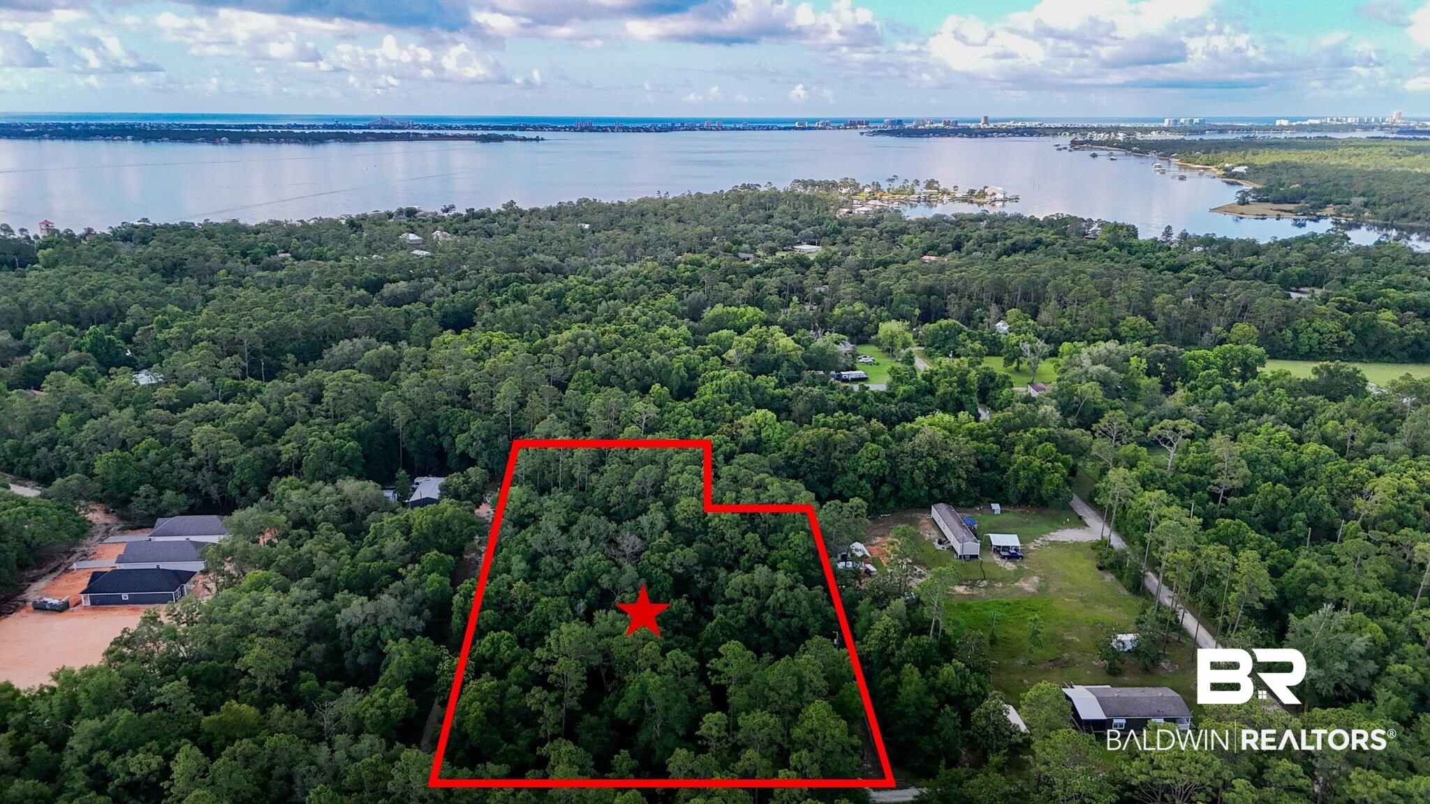 30678 Forgotten Lane Elberta, AL 36530 - Photo 1 of 5 Aerial view of property and surrounding area with a nearby body of water, a forest, and property parcel outlined