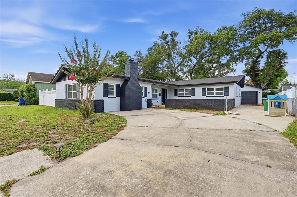 1946 Strathaven Road Winter Park, FL 32792 - Photo 1 of 37 a house with palm tree in front of it