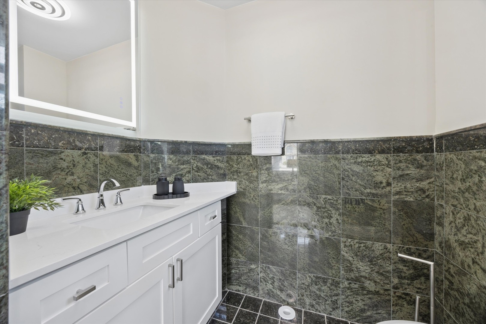 9807 West 57th Street Countryside, IL 60525 - Photo 19 of 48 a bathroom with a sink and a mirror