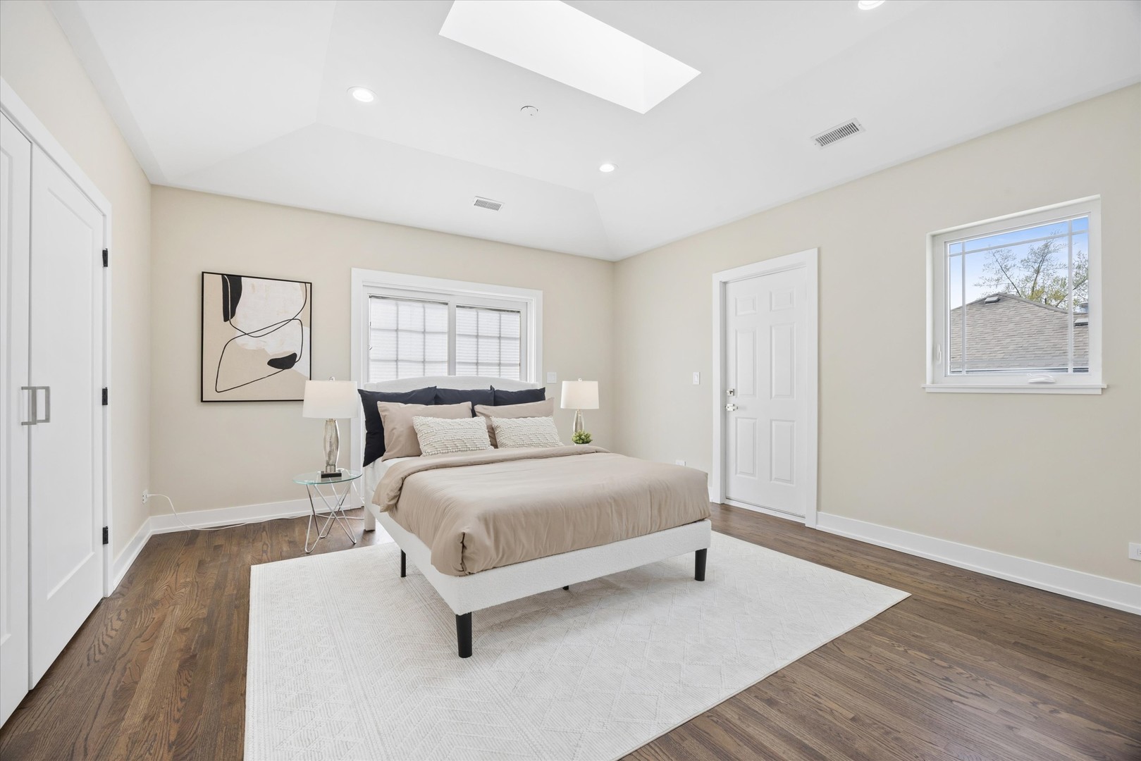 9807 West 57th Street Countryside, IL 60525 - Photo 20 of 48 a spacious bedroom with a bed and a painting on the wall