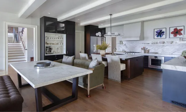 a kitchen with a table chairs sink and cabinets