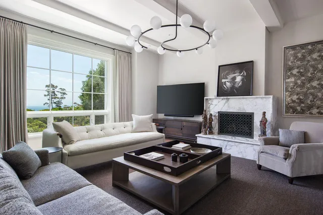 a living room with furniture a flat screen tv and a fireplace