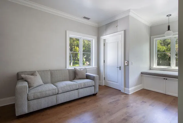 a living room with furniture and windows