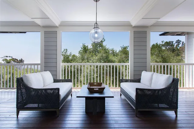 a living room with furniture a window and wooden floor