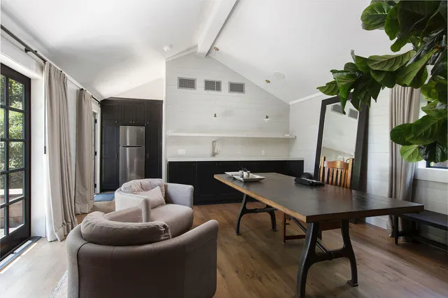 a living room with furniture potted plant and a window